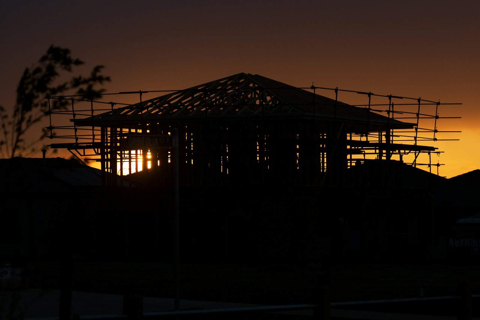The frame of a new house at sunset